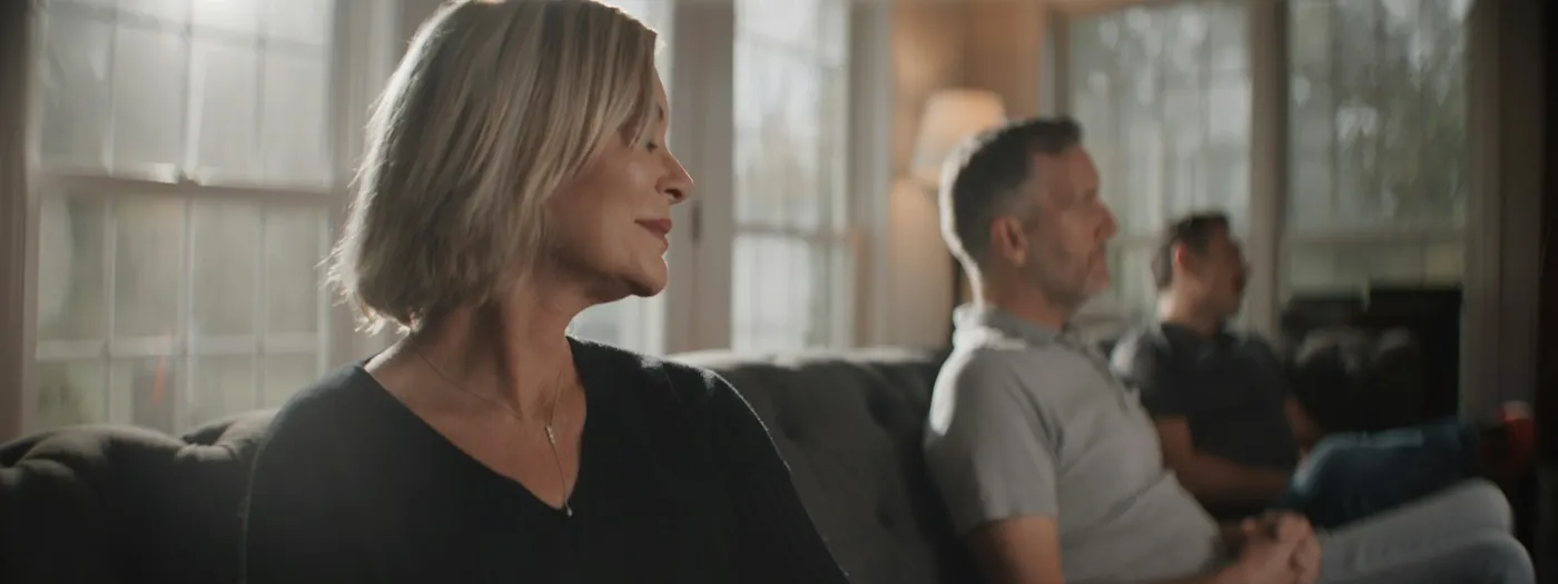 A counselor talking warmly with a couple in a bright, comfortable room